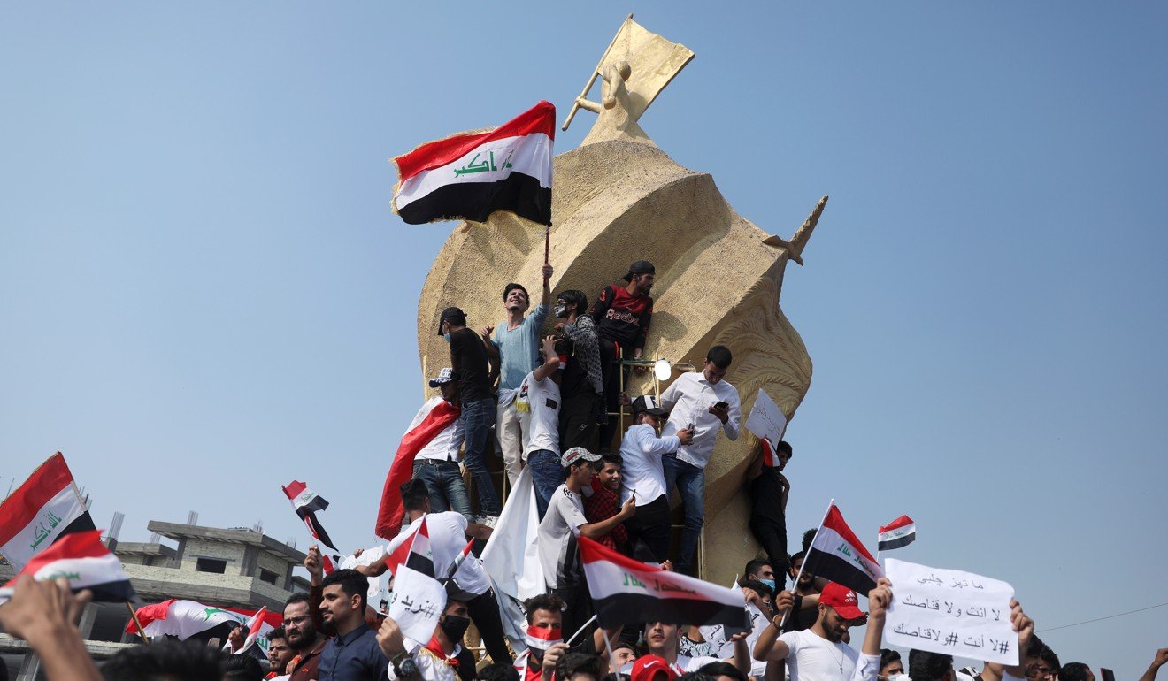 University students hold the Iraqi flag as they take part in a protest over corruption, lack of jobs, and poor services, in Karbala. Photo: Reuters