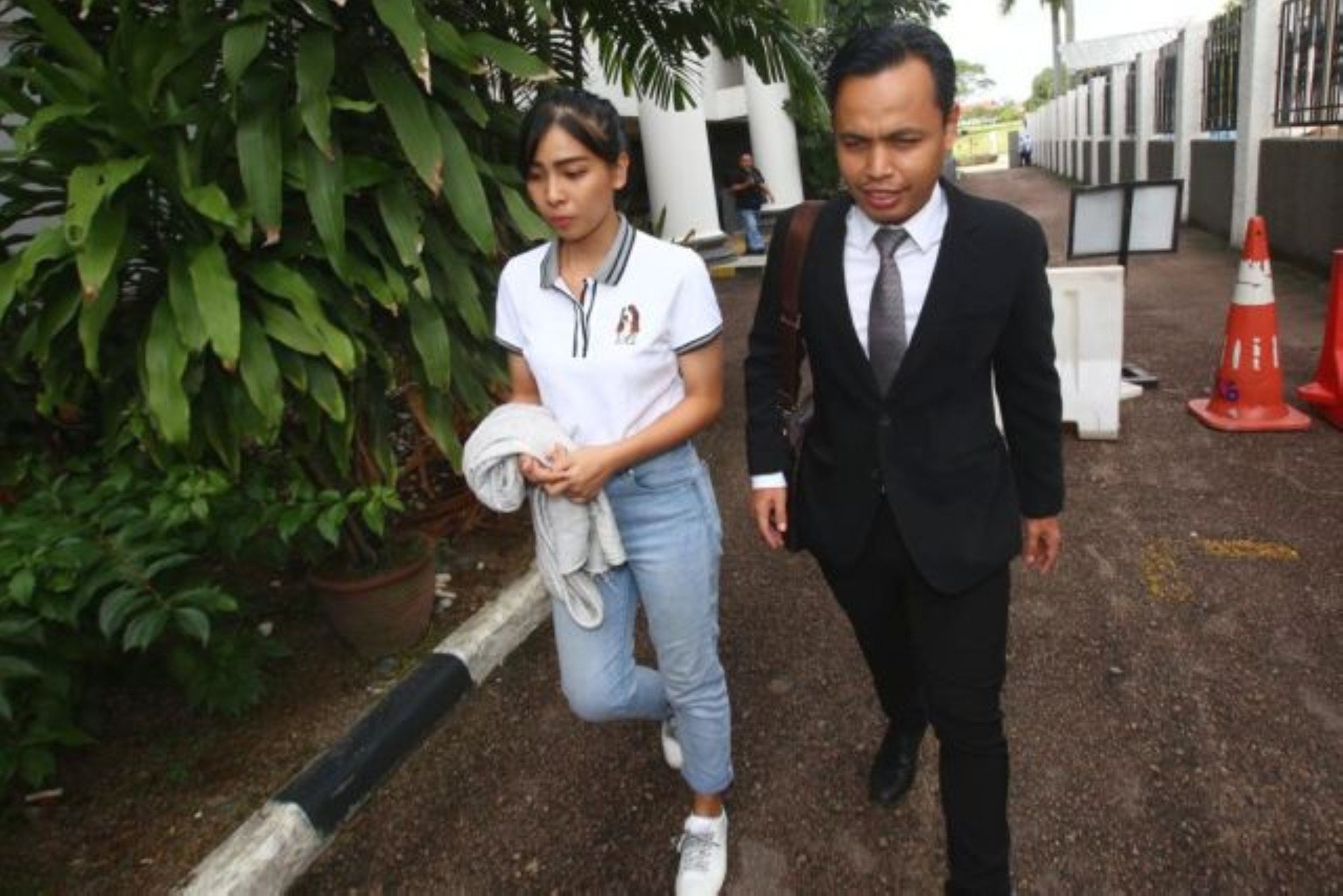 Sam Ke Ting (left, in white) leaving court in Johor Baharu. Photo: The Star Online