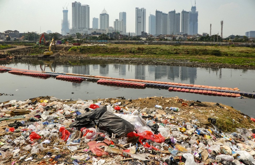 Plastic waste washes up along a river bank in Jakarta. Photo: AFP