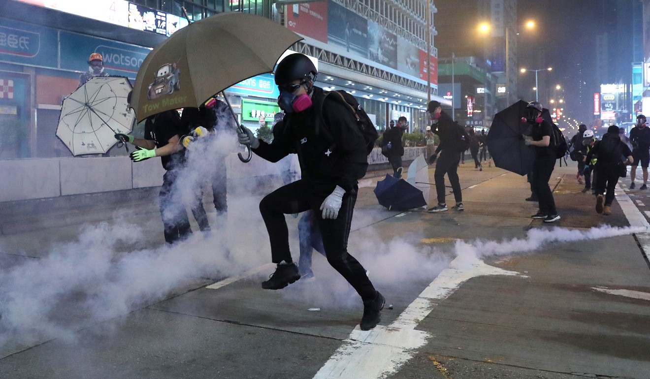 Police fire tear gas at anti-government protesters during clashes in Mong Kok on Sunday. Photo: Sam Tsang
