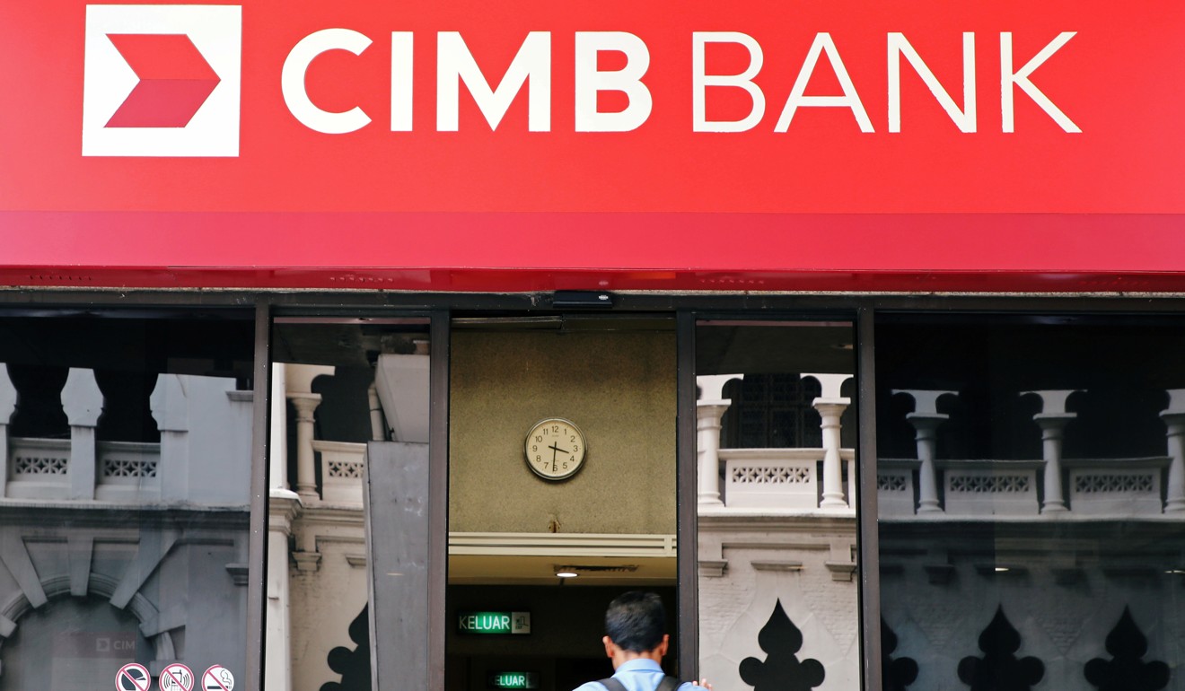 A man walks into a branch of CIMB bank in Kuala Lumpur. Photo: Reuters