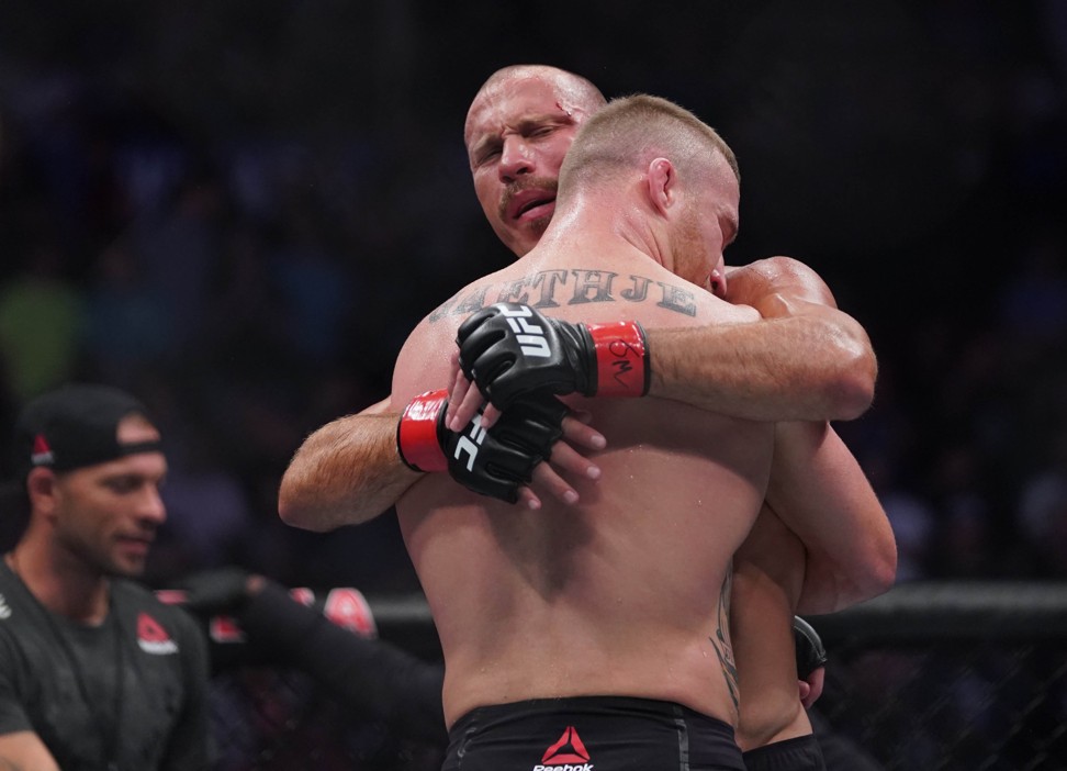 Donald Cerrone (red gloves) embraces Justin Gaethje after losing their fight. Photo: USA Today Sports