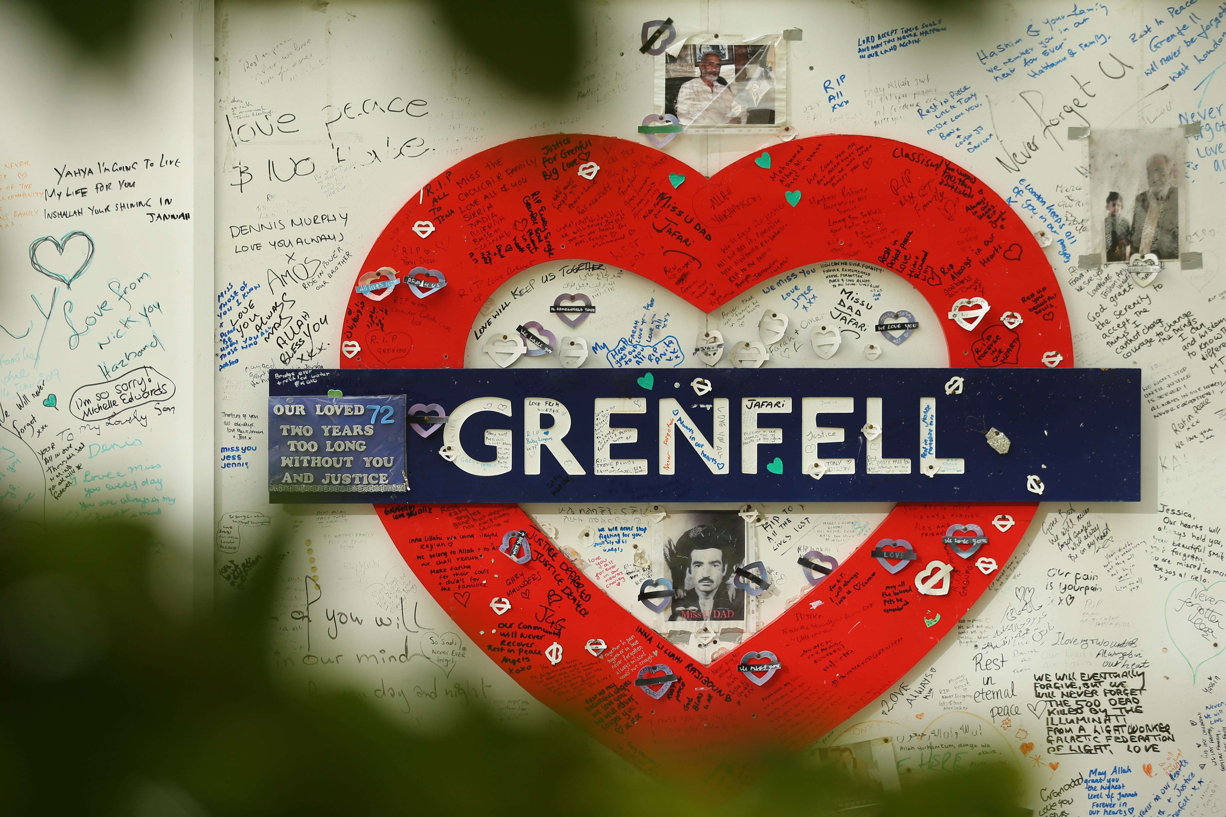 Messages of support are written on a wall surrounding Grenfell Tower in London on Wednesday. Photo: AFP