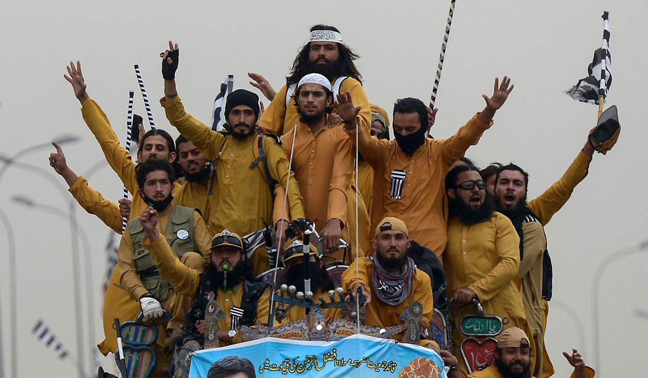 Supporters of the Islamist Jamiat Ulema-e-Islam (JUI-F) party wave flags atop a vehicle. Photo: AFP