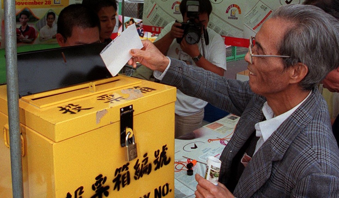 An elderly man practises voting at the Kowloon West election carnival. Photo: Handout