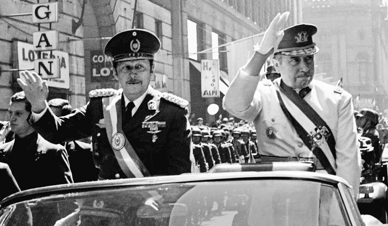 Alfredo Stroessner (left) of Paraguay and Augusto Pinochet of Chile ride in an open car through downtown Santiago, Chile, during a visit by Stroessner in September 1974. Both Stroessner and Pinochet led repressive military dictatorships which benefited from US support. Photo: Reuters