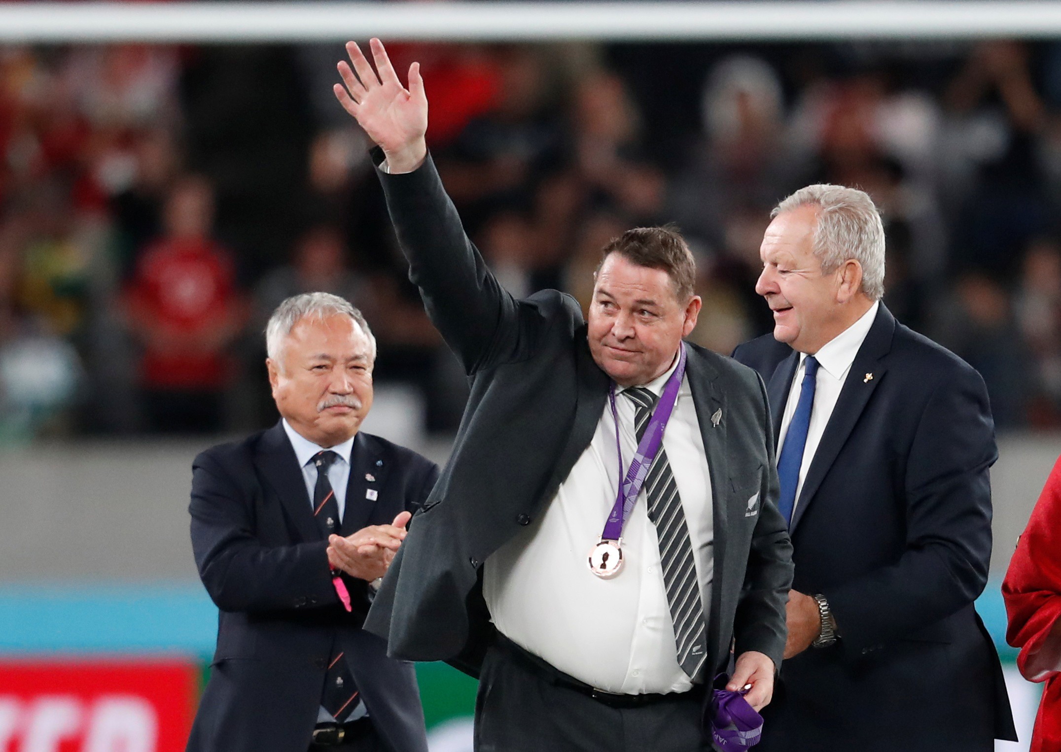 New Zealand head coach Steve Hansen after receiving his bronze medal from Japan Rugby Football Union president Shigetaka Mori and World Rugby chairman Bill Beaumont. Photo: Reuters