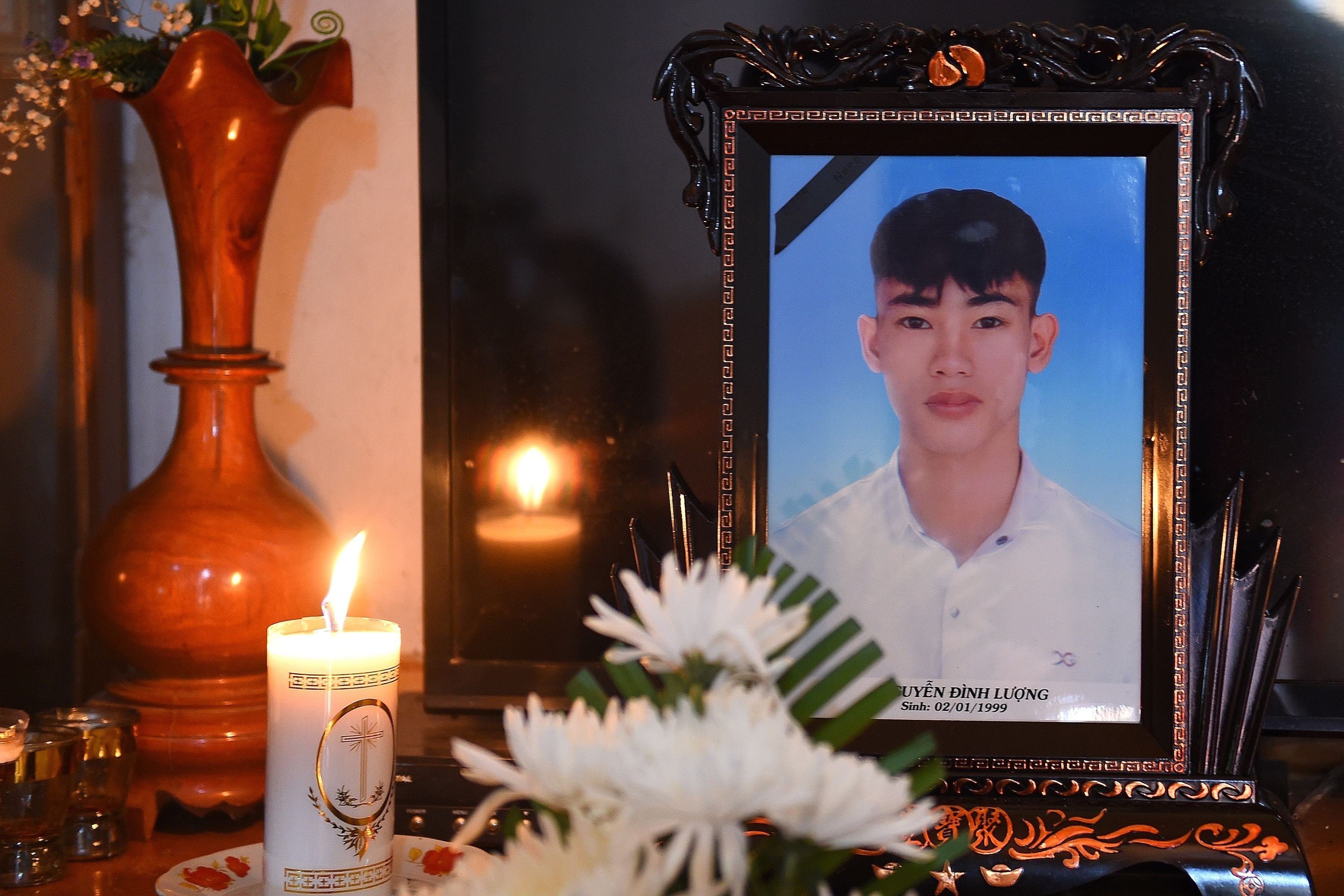 A portrait of 20-year-old Nguyen Dinh Luong, who is feared to be among the 39 people found dead in a truck in Britain, is kept on a prayer altar at his house in Vietnam's Ha Tinh province. Vietnamese police are cracking down on people smuggling. Photo: AFP