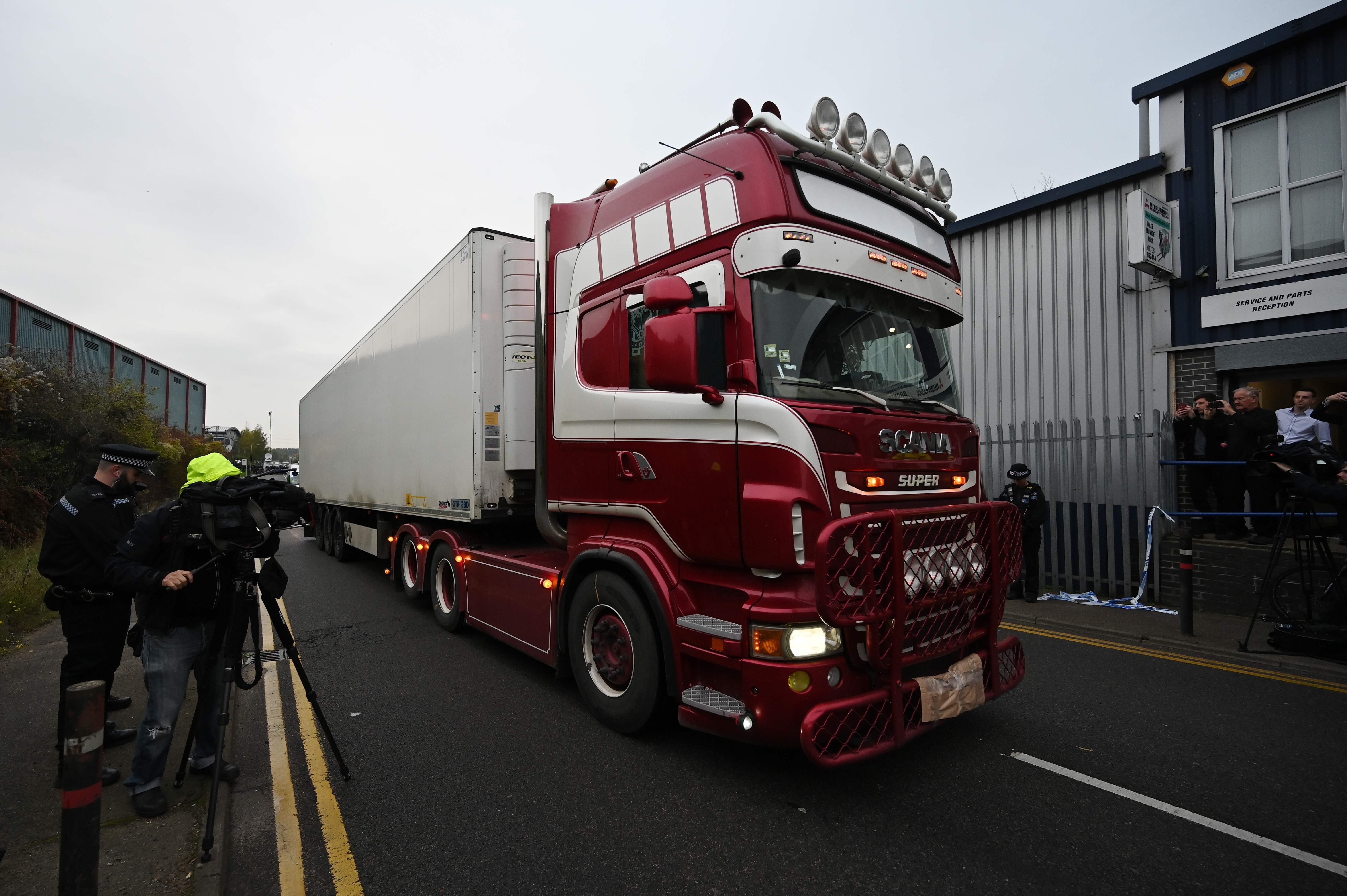 Police officers drive away a truck in which 39 bodies were discovered in Britain. Photo: AFP