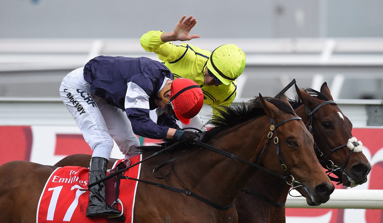 Joao Moreira (inside) pats Kerrin McEvoy (outside) on the back after he was nosed out in the finish in the 2016 Melbourne Cup. Photo: EPA/DAN HIMBRECHTS