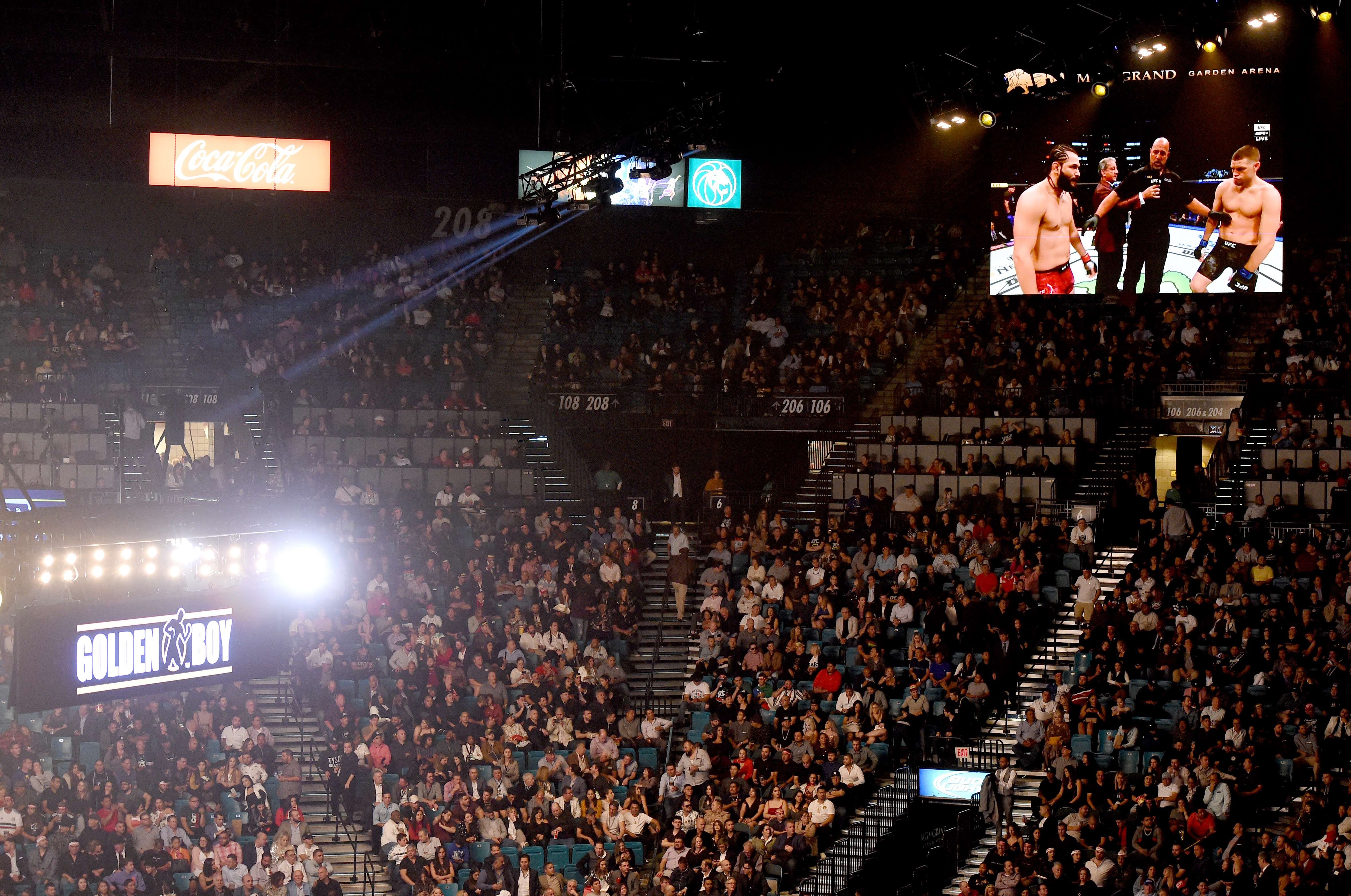 The UFC 244 welterweight bout between Jorge Masvidal and Nate Diaz is shown on screens at MGM Grand Garden Arena. Photo: AFP
