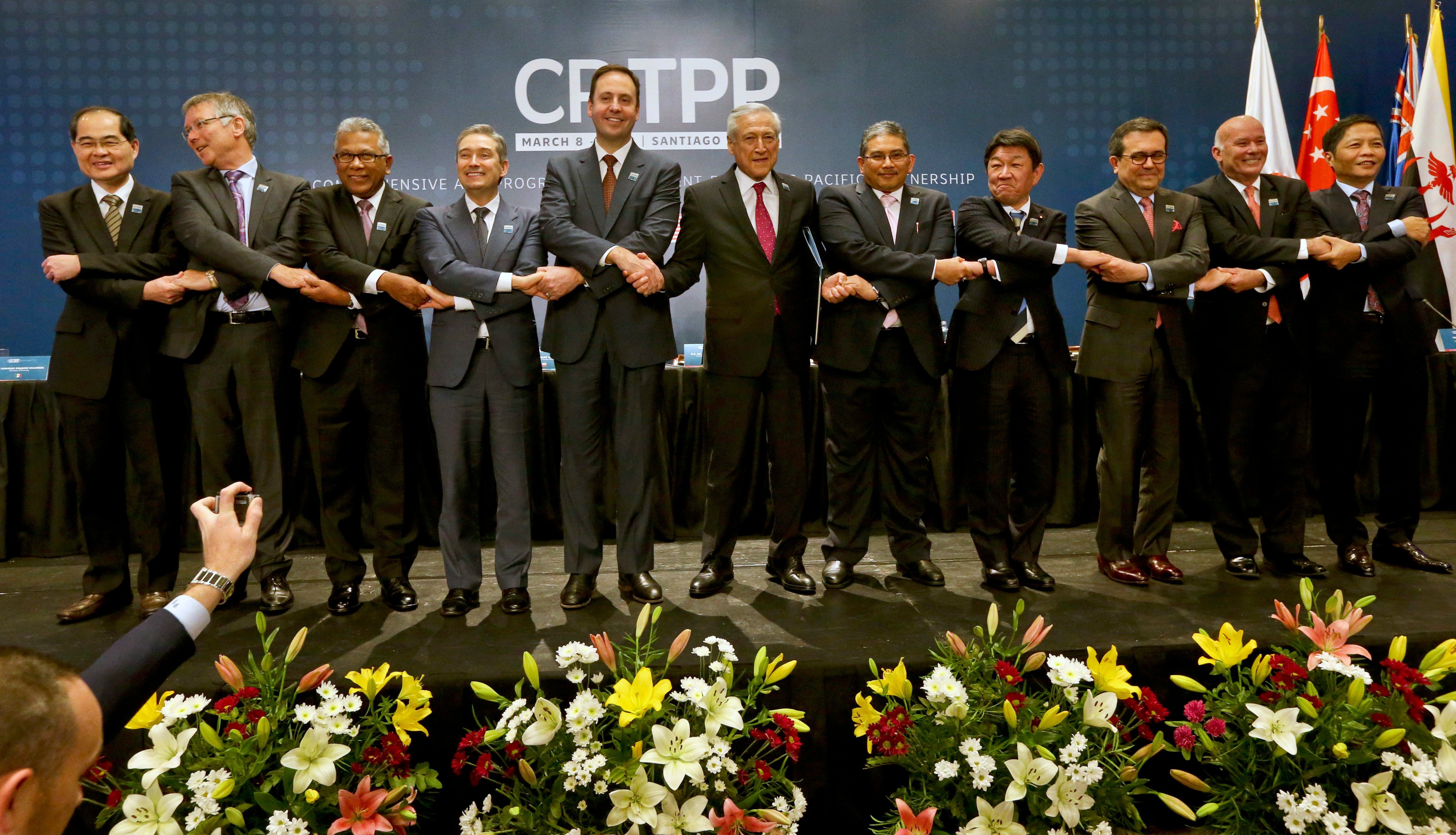 Ministers join hands after the signing ceremony of the Comprehensive and Progressive Agreement for Trans-Pacific Partnership in Santiago, Chile, in March 2018. Eleven countries formed the CPTPP after the US pulled out of Obama-led TPP. Photo: AP