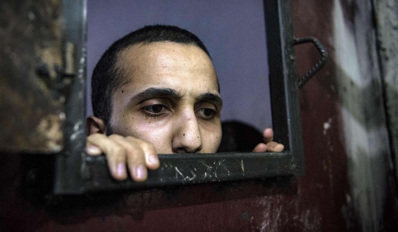 An inmate looks out from his cell. Photo: AFP