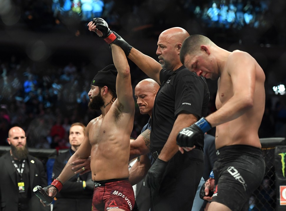 Jorge Masvidal’s hand is raised as Nate Diaz looks dejected. Photo: USA TODAY Sports