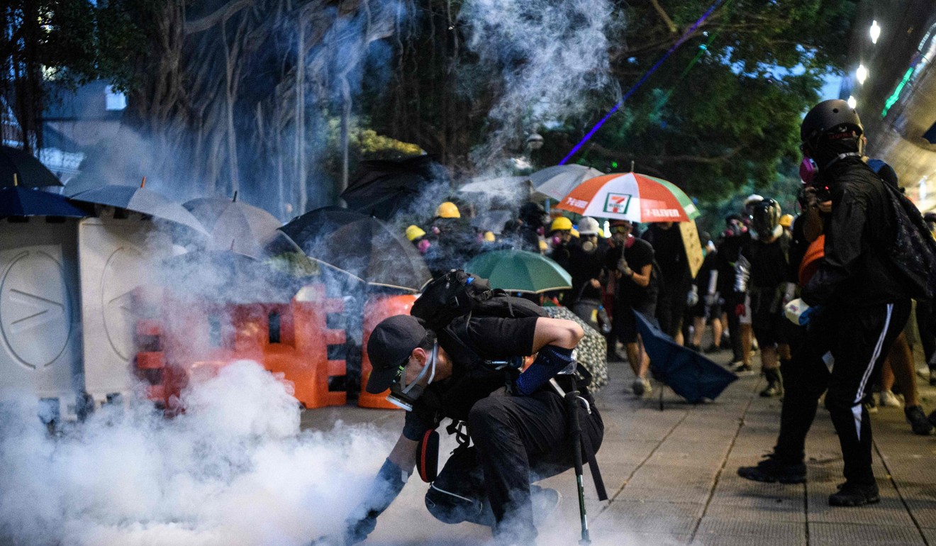 Protesters fight off tear gas in Tsim Sha Tsui on August 11, the night the woman sustained her serious eye injury and was admitted to hospital. Photo: AFP