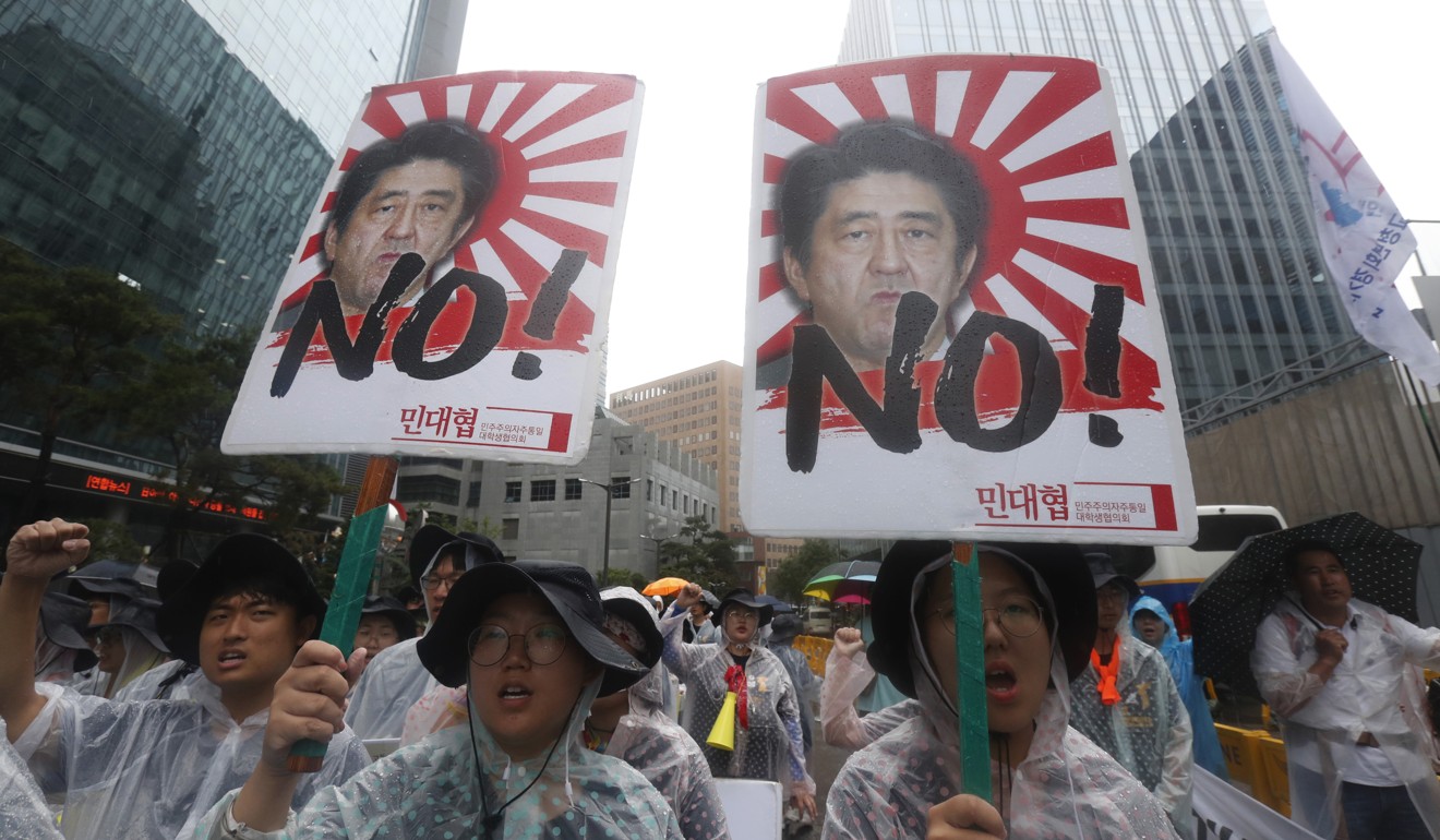 South Korean protesters with images of Japanese Prime Minister Shinzo Abe mark the South Korean Liberation Day from Japanese colonial rule in front of the Japanese Embassy in Seoul in August. Photo: AFP