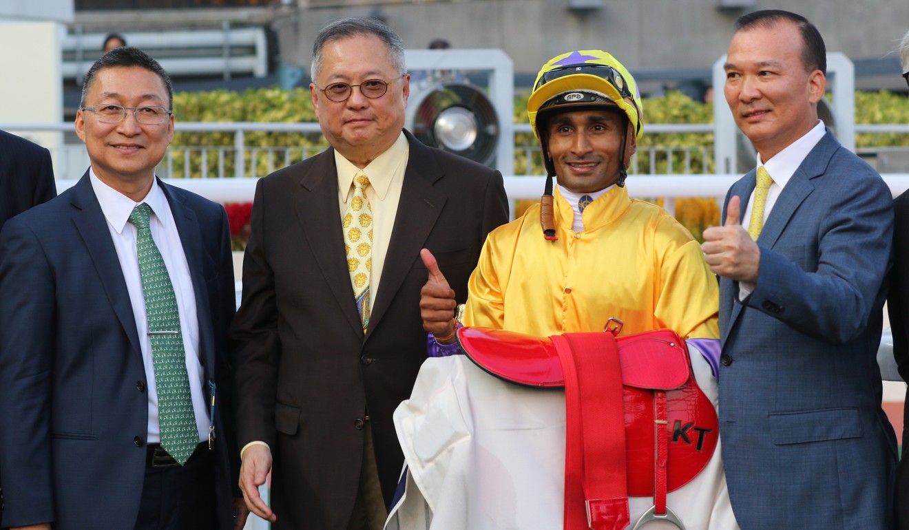 Trainer Francis Lui (left) and jockey Karis Teetan celebrate with connections.