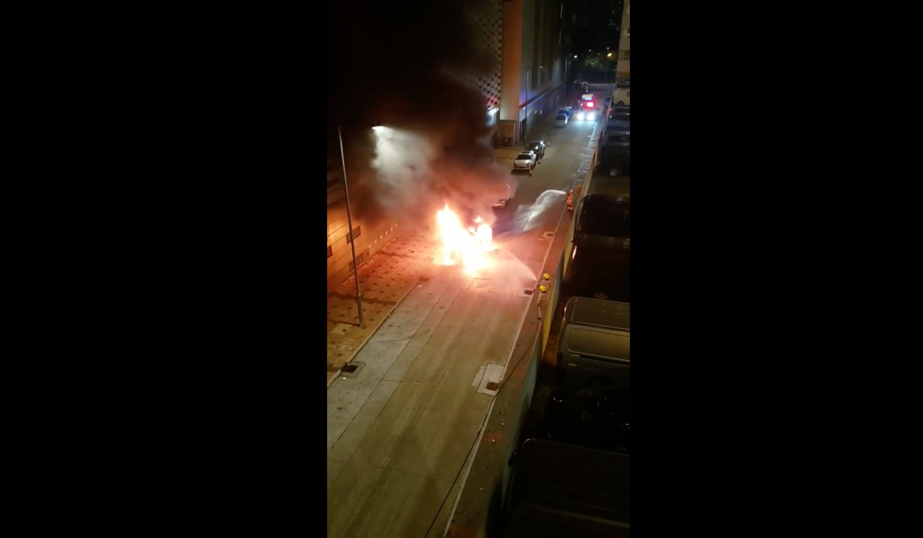 A seven-seater car burst into flames outside a factory building in Wang Mau Street, Kowloon Bay. Photo: Facebook