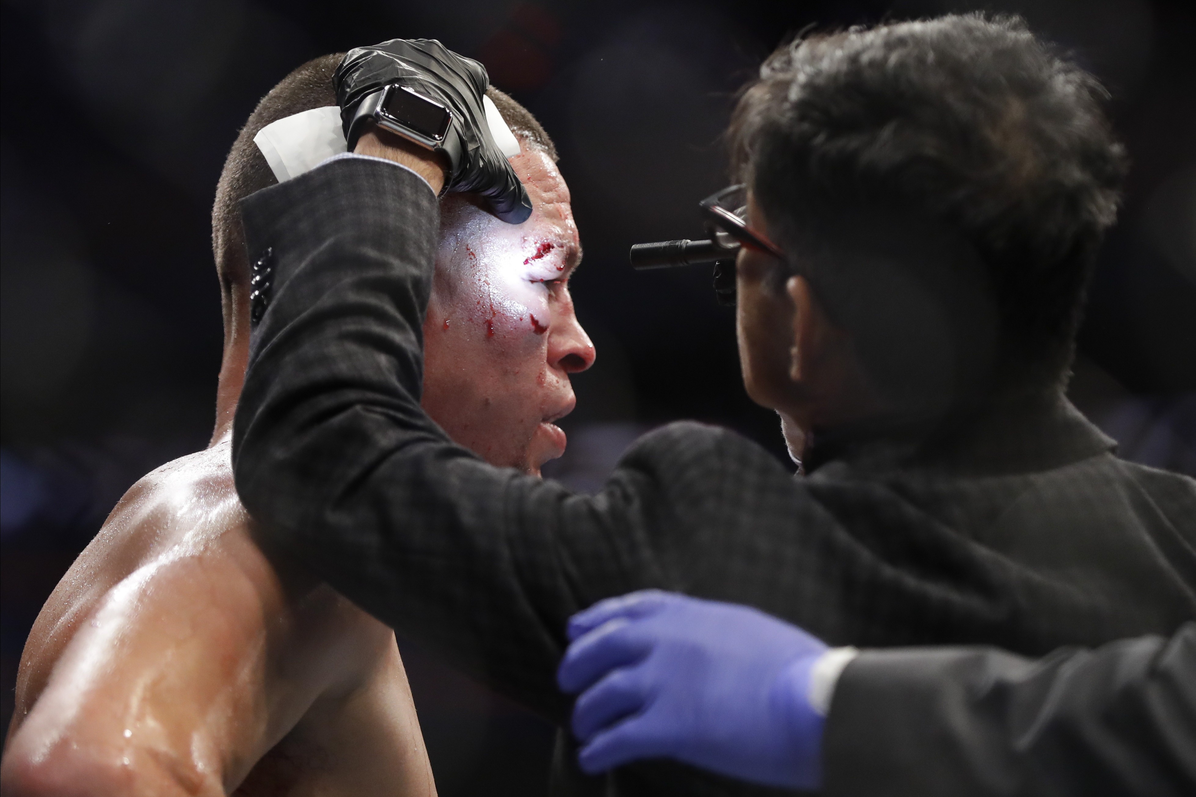 Dr Nitin K. Sethi checks Nate Diaz before the fourth round at UFC 244. Photo: AP