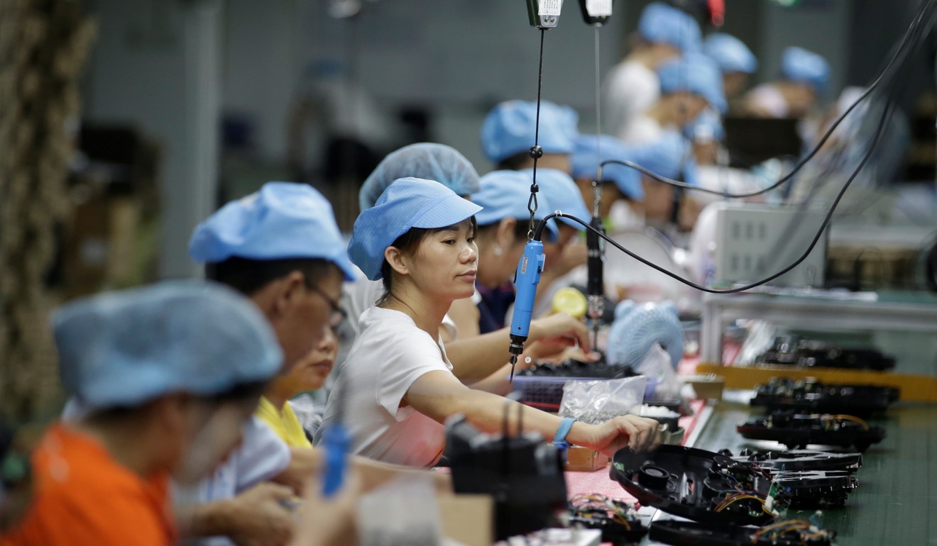 Employees work on the production line of a robot vacuum cleaner factory in Shenzhen, China, on August 9. A gauge of confidence among Chinese factory owners in October came in at slightly lower than analysts’ forecasts. Photo: Reuters