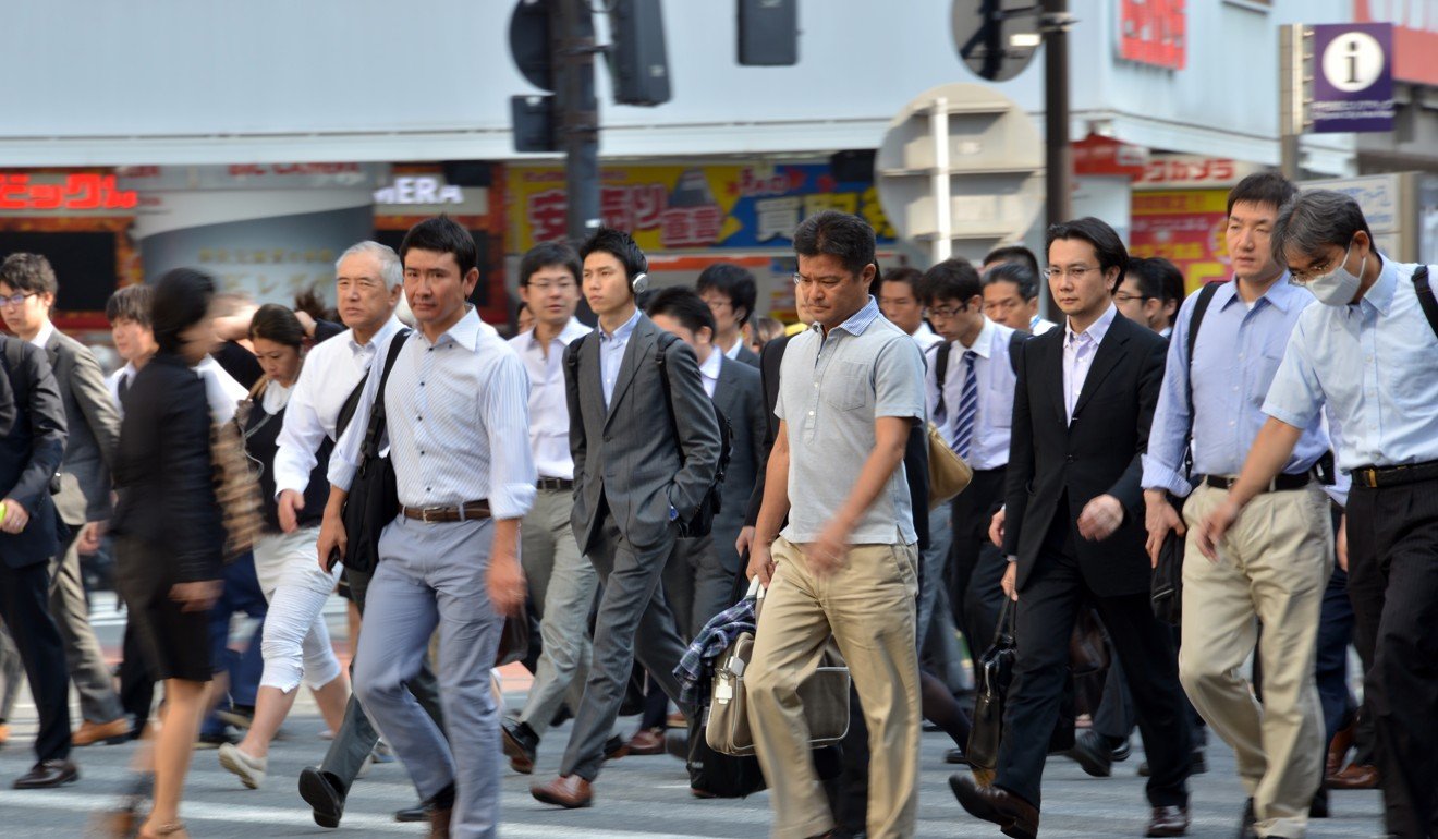 Japan’s notoriously overworked businessmen, called salarymen, heading to their office in Tokyo. Photo: AFP