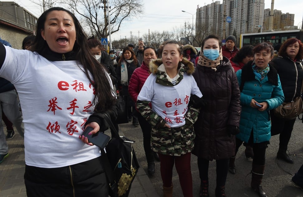 Investors in Chinese online peer-to-peer lender Ezubao chanting slogans during a protest in Beijing after the platform turned out to be a giant Ponzi scheme. Photo: AFP