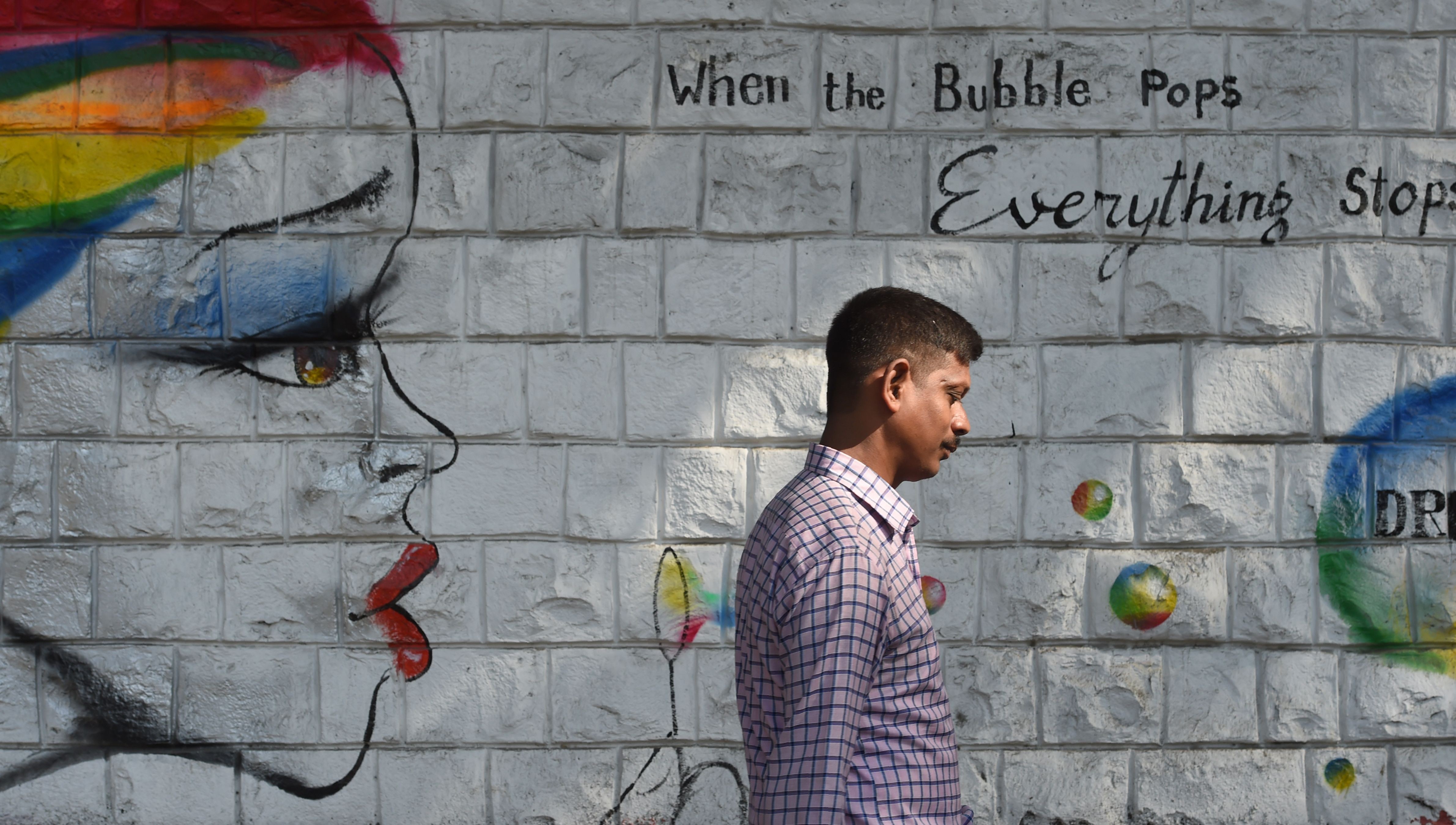 A man walks past graffiti on female empowerment in Mumbai in December 2017. In 2018, Indian women joined those across the world in sharing their stories of being sexually harassed under the hashtag #MeToo. Photo: AFP