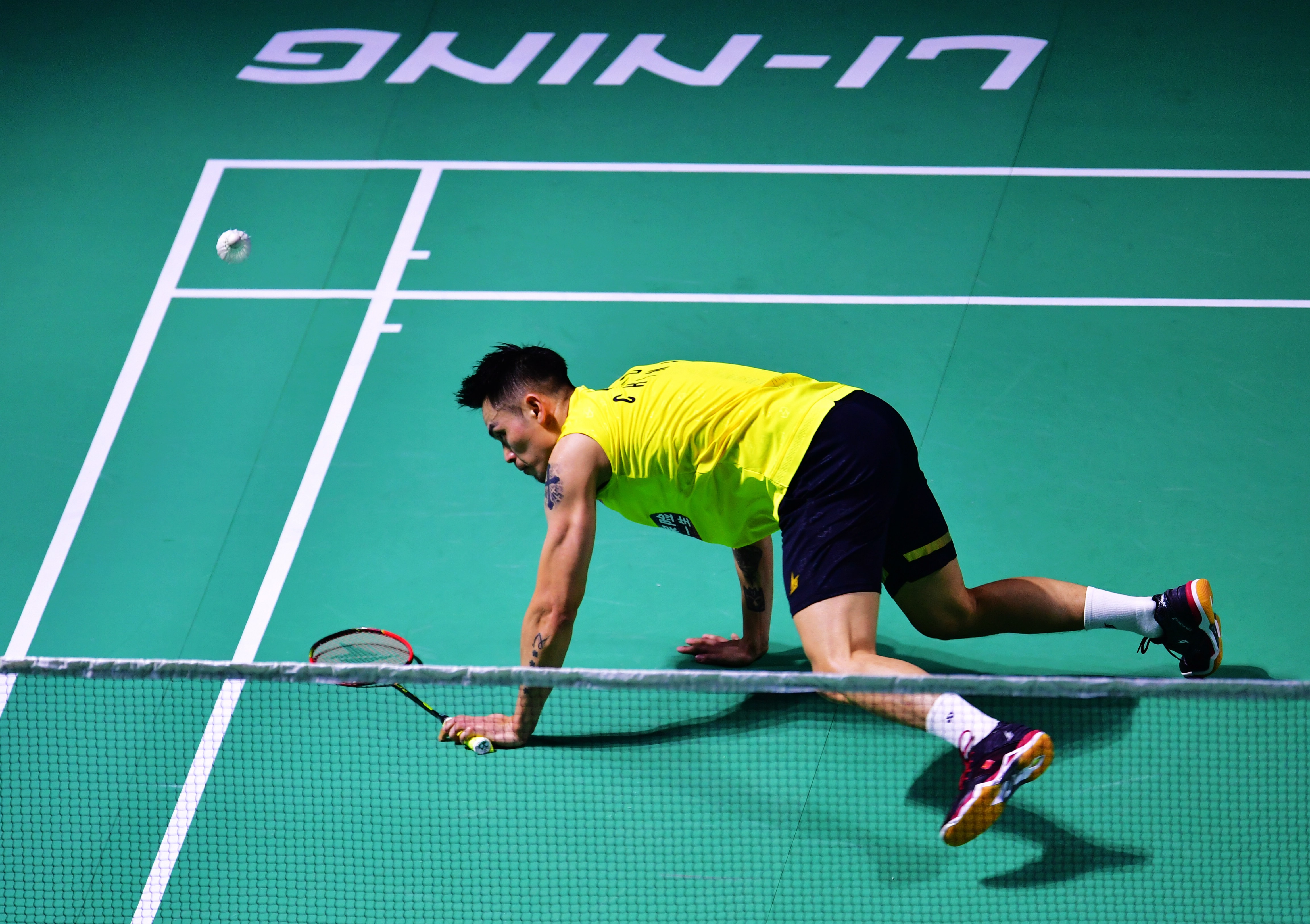 Down and out ... China’s Lin Dan slips during his first-round defeat at the China Open on Wednesday. Photos: Xinhua