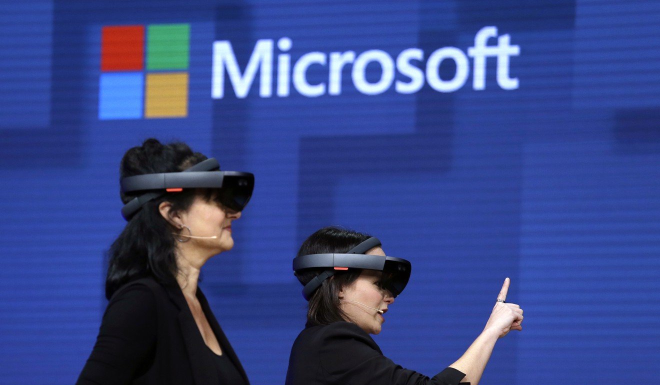 Microsoft staff demonstrate the company’s technology in Seattle. The IT company in Japan trialled a four day work week. Photo: AP
