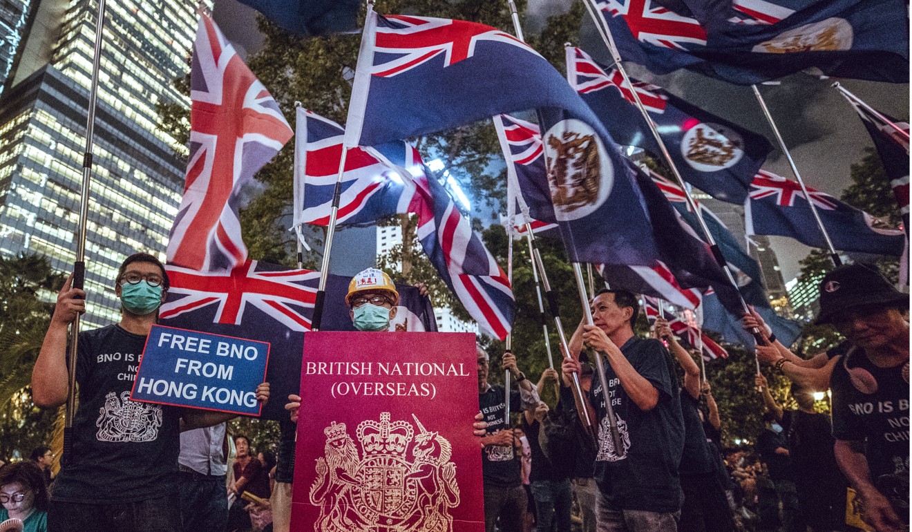 Protesters waving Hong Kong colonial flags and a gigantic British National (Overseas) passport during a rally in August. Photo: Winson Wong
