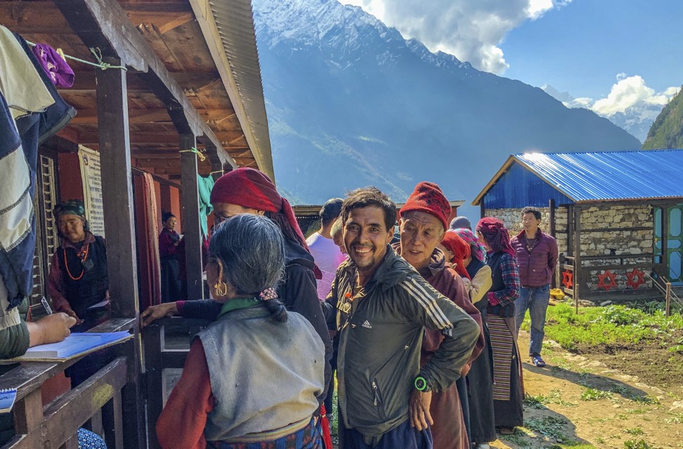 Villagers waiting outside an eye-screening clinic, one of six that was set up in the Nubri Valley for the project. Photo: Cathryn Donohue
