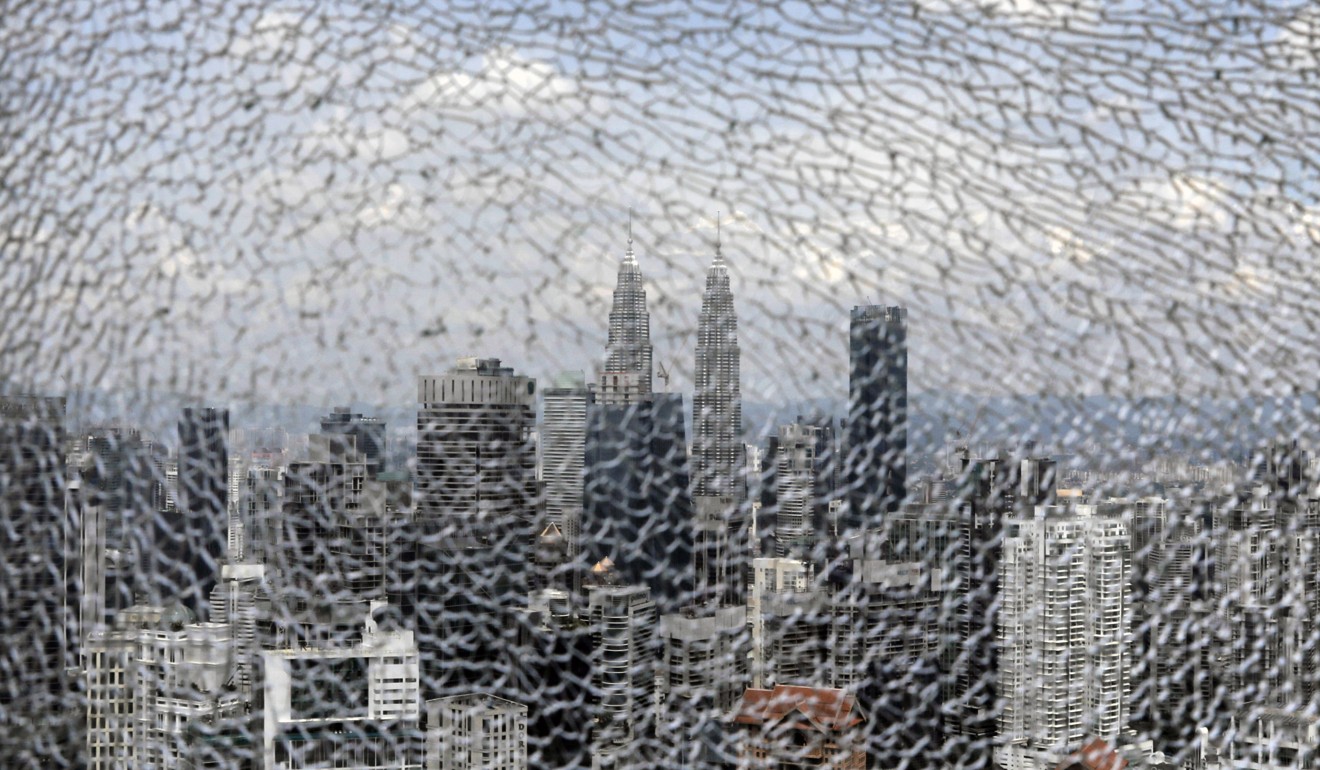 The Kuala Lumpur skyline, seen through a shattered glass pane inside The Exchange 106 tower in the city’s financial district. Photo: Bloomberg