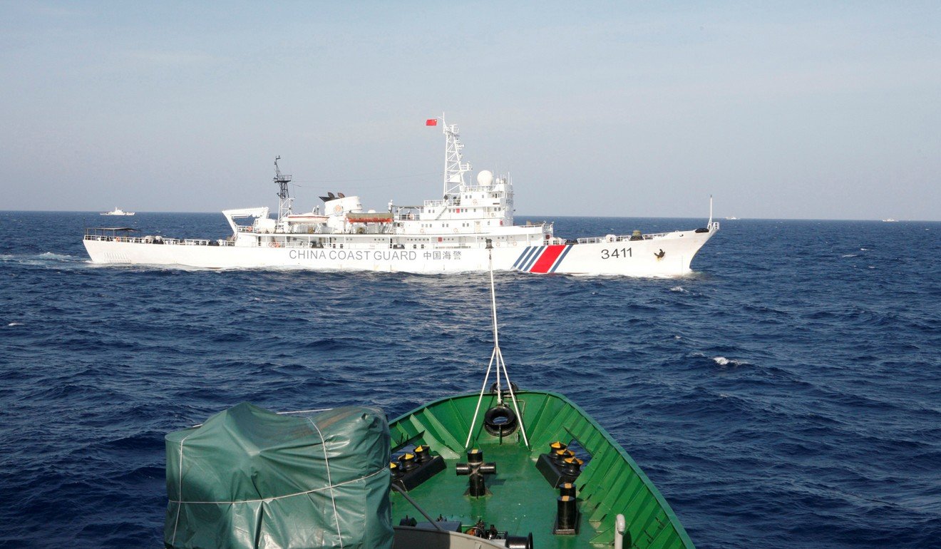 A Chinese coastguard ship sails by a Vietnamese vessel off the coast of Vietnam in 2014. Photo: Reuters