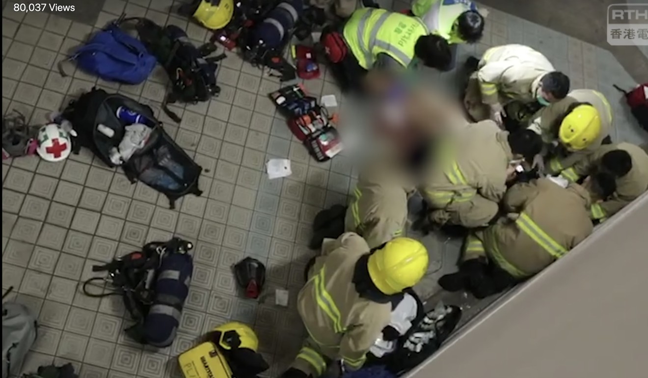 Rescue workers help student Chow Tsz-lok after his fall. Photo: RTHK