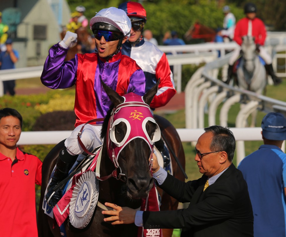 Alfred Chan pumps his fist after winning with Encouraging.