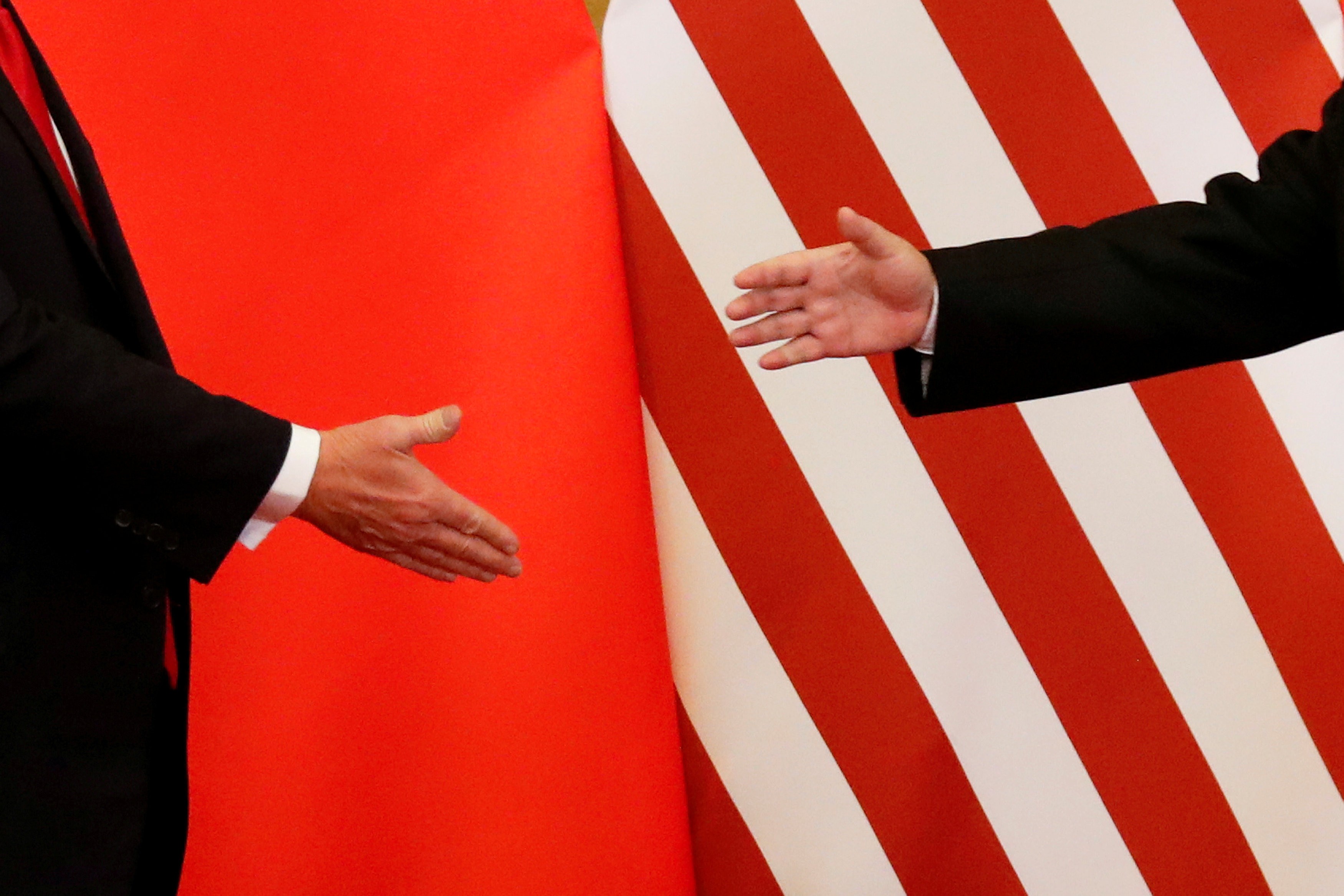 US President Donald Trump and Chinese President Xi Jinping shake hands at the Great Hall of the People in Beijing on November 9, 2017. Photo: Reuters