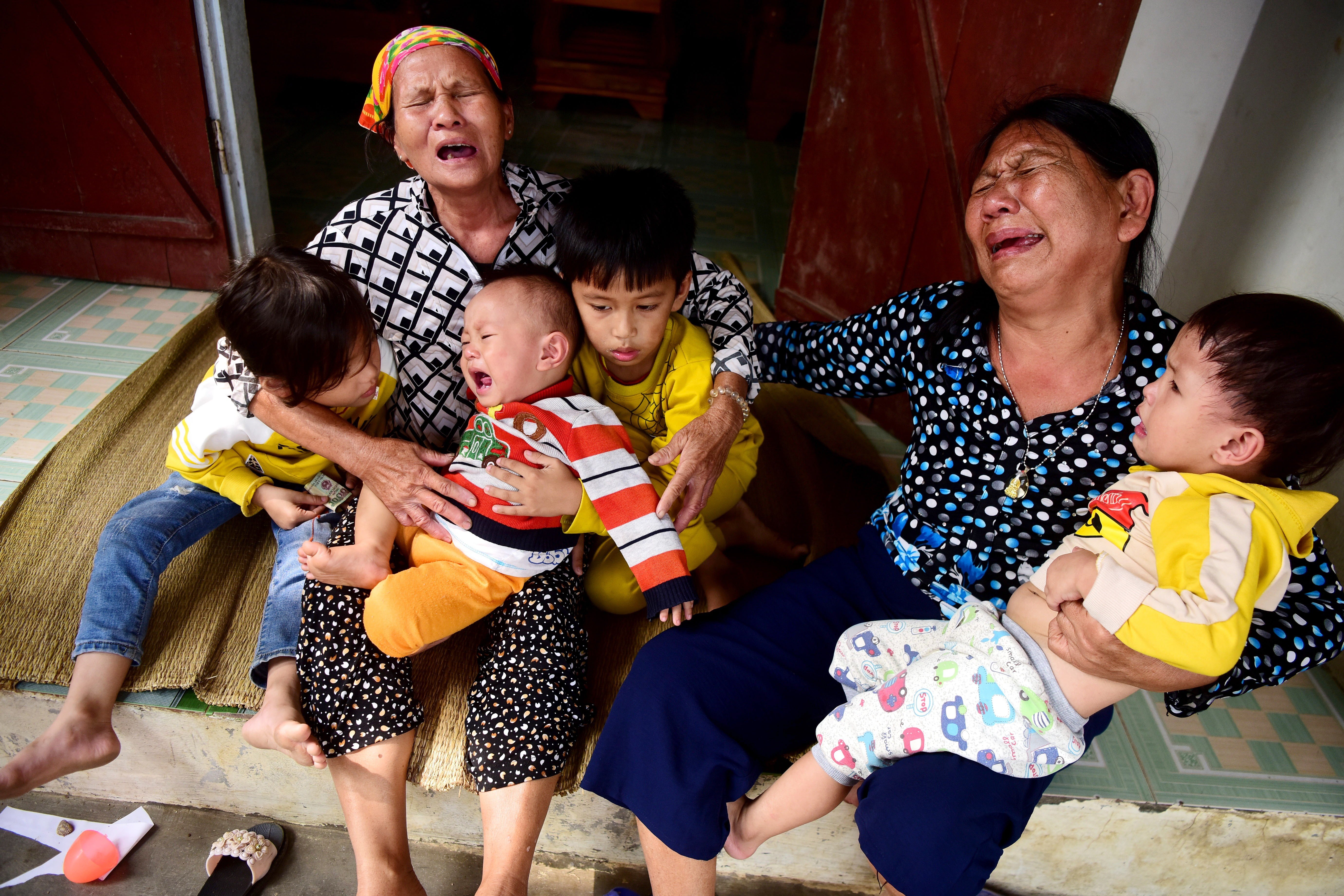 Family members of one of the victims react to the news of their death from their home in Nghe An province, Vietnam. Photo: EPA