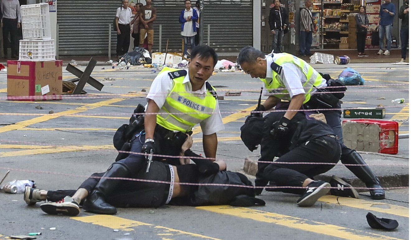 The protester on the left was shot with one live round. Photo: Nora Tam