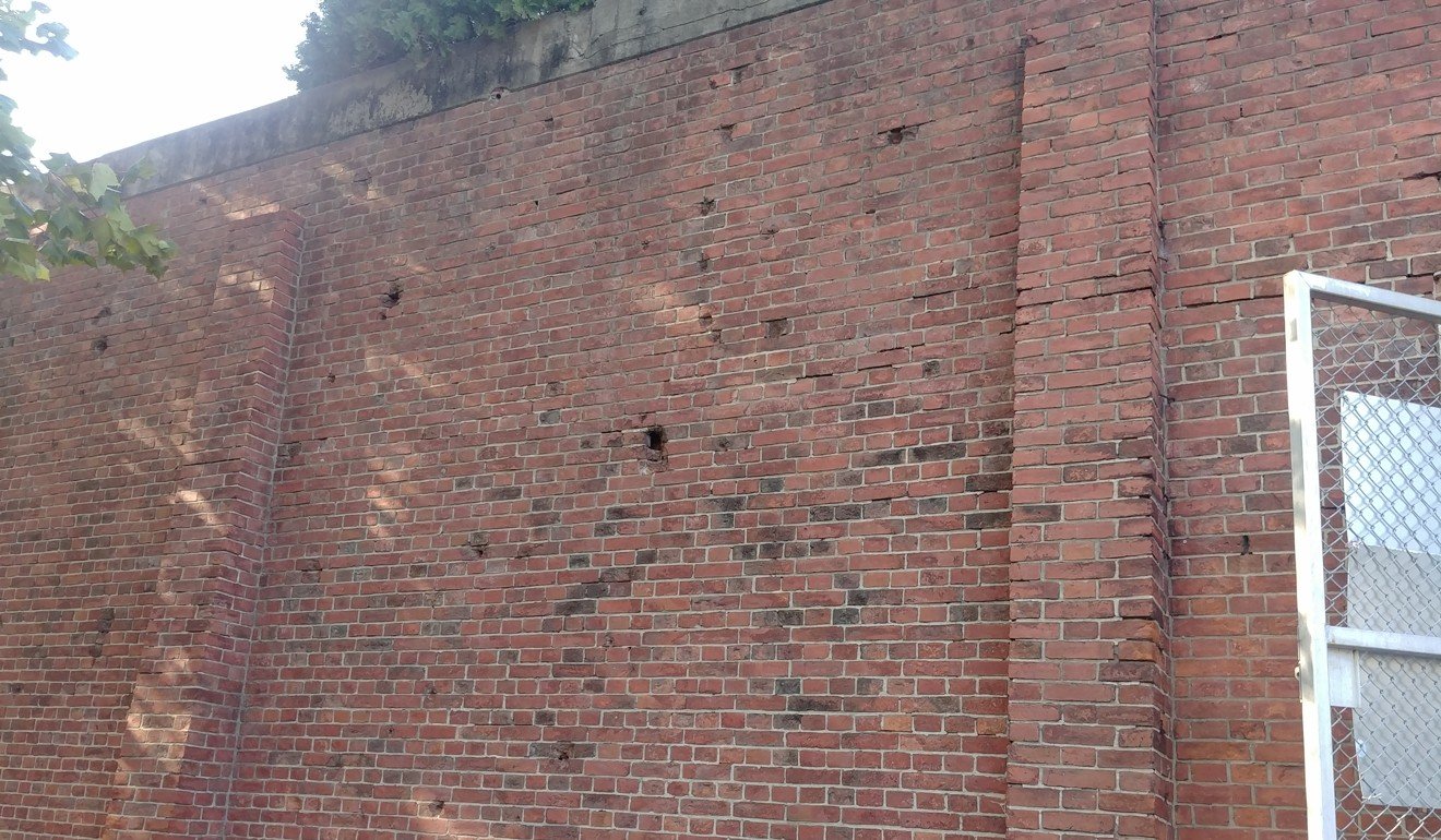 Bullet holes and other damage from the Korean war can be seen on the wall of a former Japanese military prison at Yongsan Garrison. The garrison was later turned into a US military prison. Photo: Park Chan-kyong