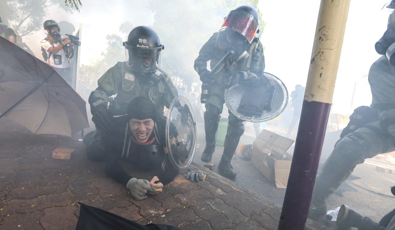 Riot police fire tear gas and arrest protesters outside Chinese University in Sha Tin early on Monday. Photo: Felix Wong