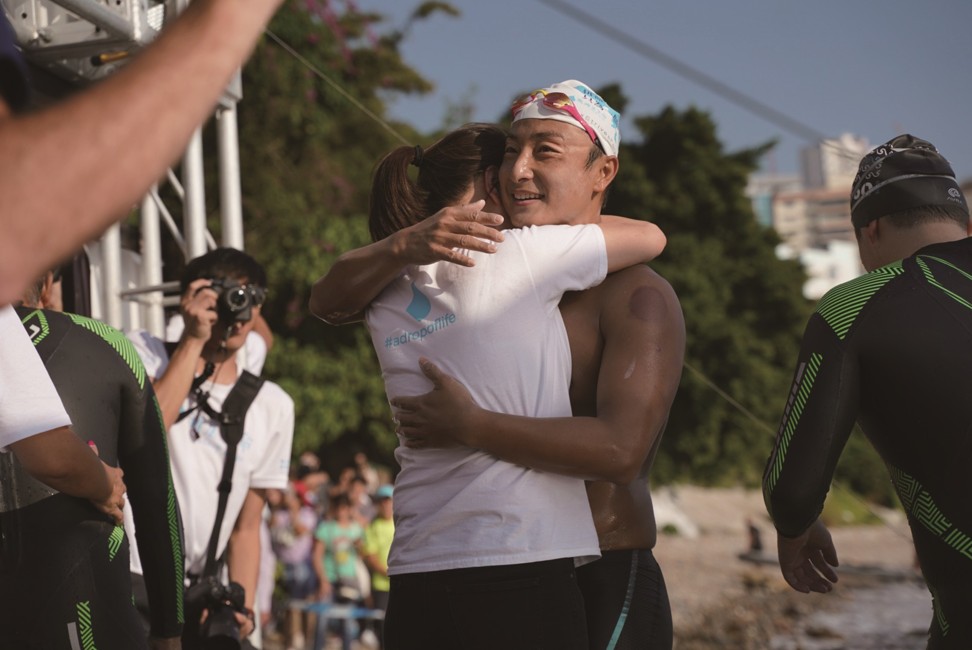 An exhausted but happy Fong as family and friends greet him after his marathon swim for charity.