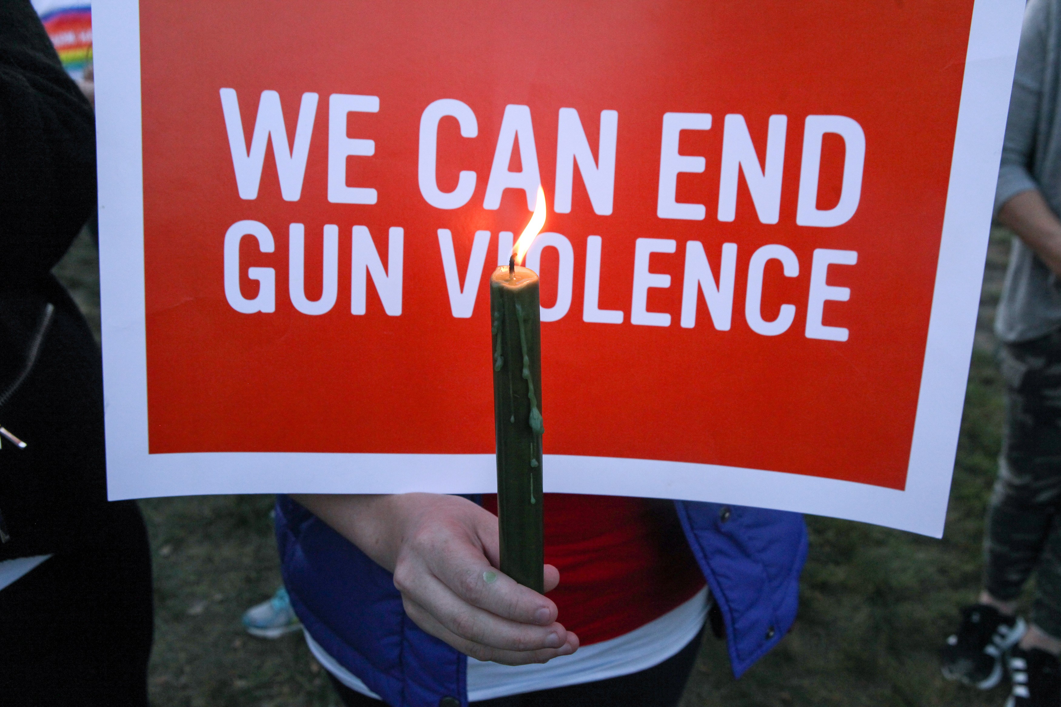 A mourner holds a sign during a vigil in memory of victims of gun violence in the US. Photo: Reuters