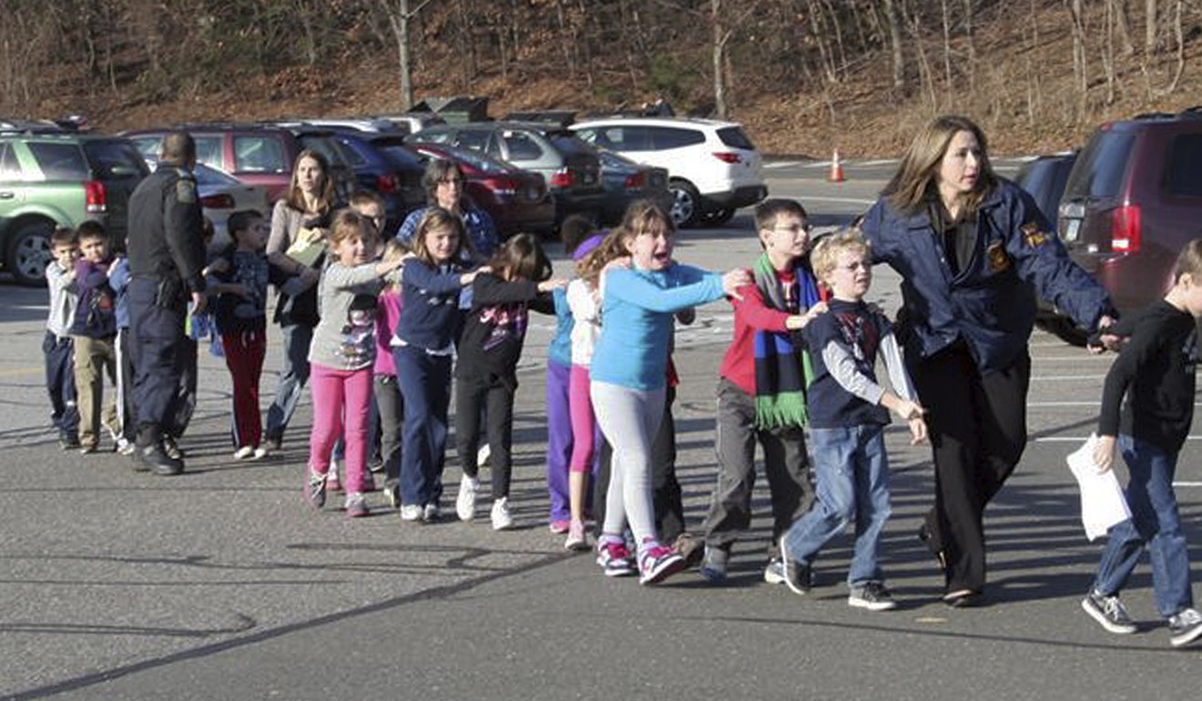 Connecticut State Police leading children away from the Sandy Hook Elementary School following the shooting. Photo: AP