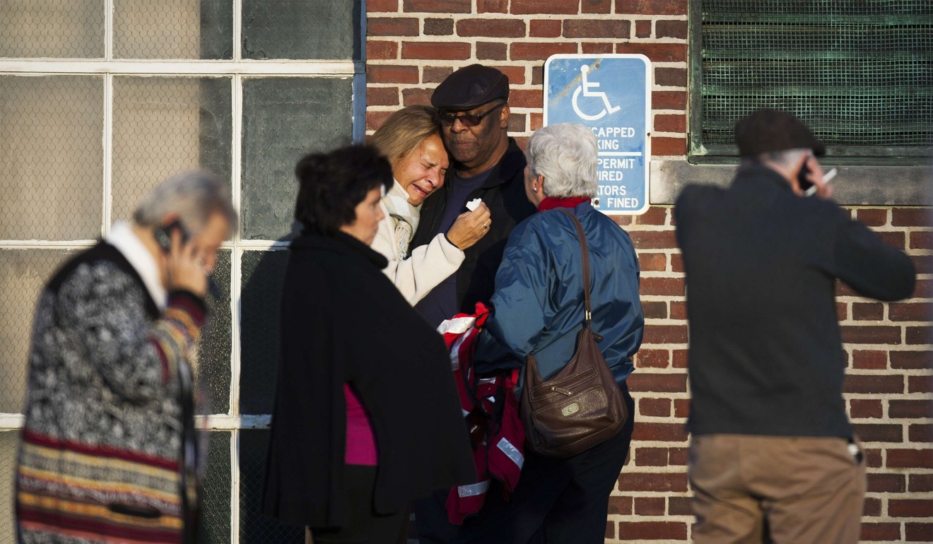 Family members of victims embrace outside a counselling session held in the wake of the shooting at Sandy Hook. Photo: Reuters
