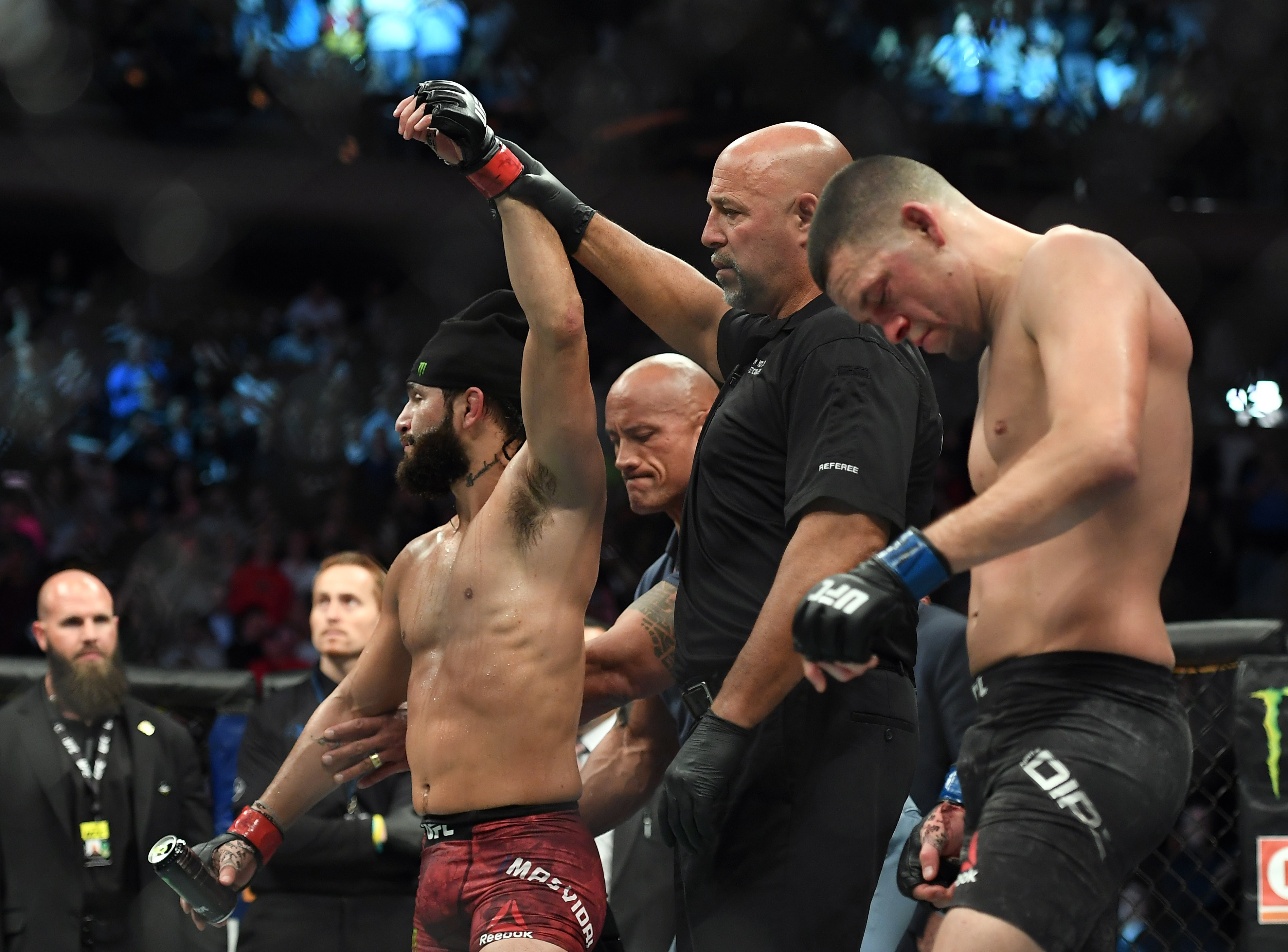 Nate Diaz looks dejected as Dwayne ‘The Rock’ Johnson raises Jorge Masvidal’s arm at UFC 244. Photo: USA TODAY Sports