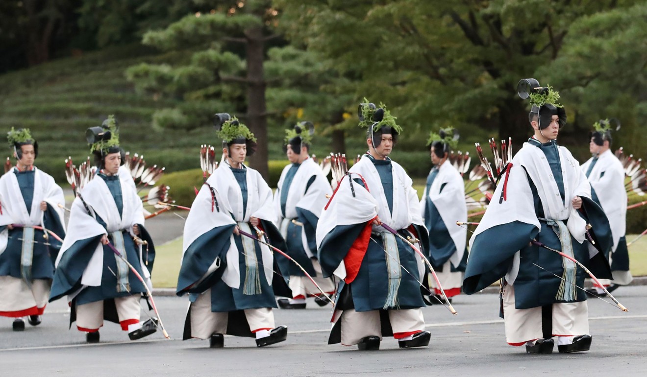 Prticipants wearing Japanese traditional costumes enter the Daijokyu venue to attend the Daijosai ritual. Photo: AFP