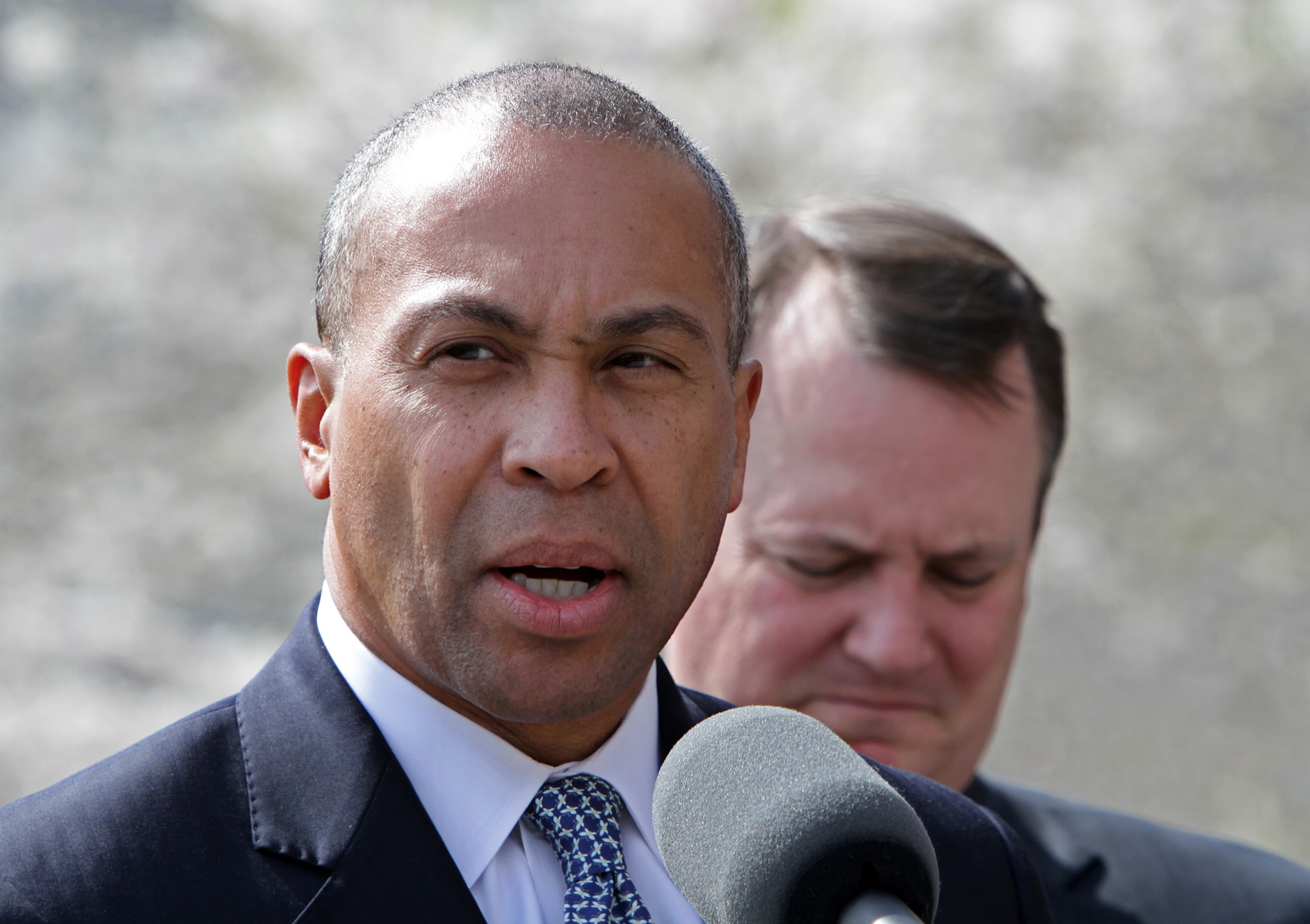 Then Governor Deval Patrick (left, with then Lieutenant Governor Tim Murray) speaks before a moment of silence for marathon bombing victims at the statehouse in Boston, Massachusetts, in April 2013. Photo: Boston Herald via TNS