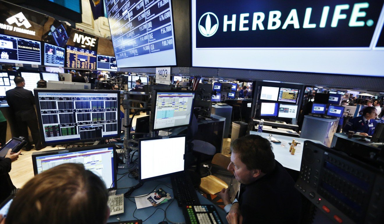 Traders work at the post that trades Herbalife stock on the floor of the New York Stock Exchange in January 2013. Photo: Reuters