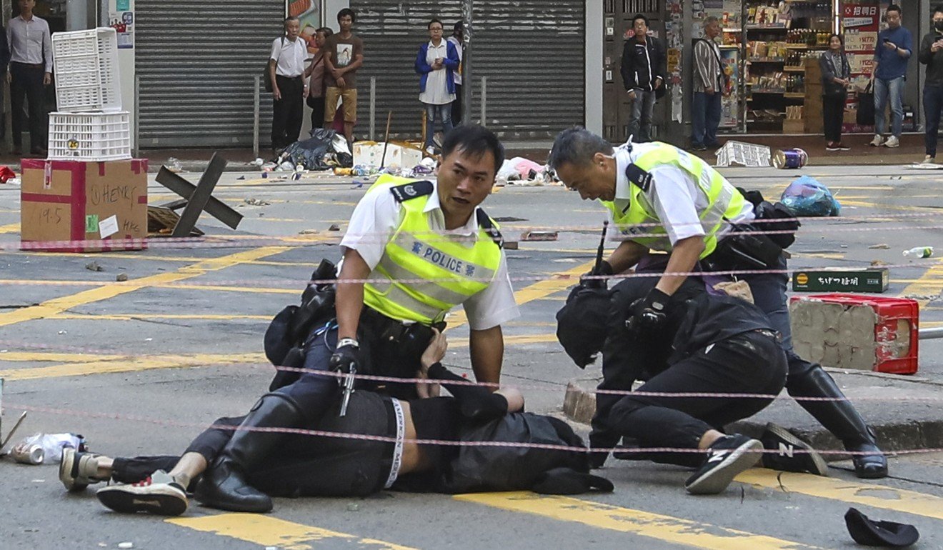 Student Chow Pak-kwan (on ground, left) was shot by police but is recovering. Photo: Nora Tam