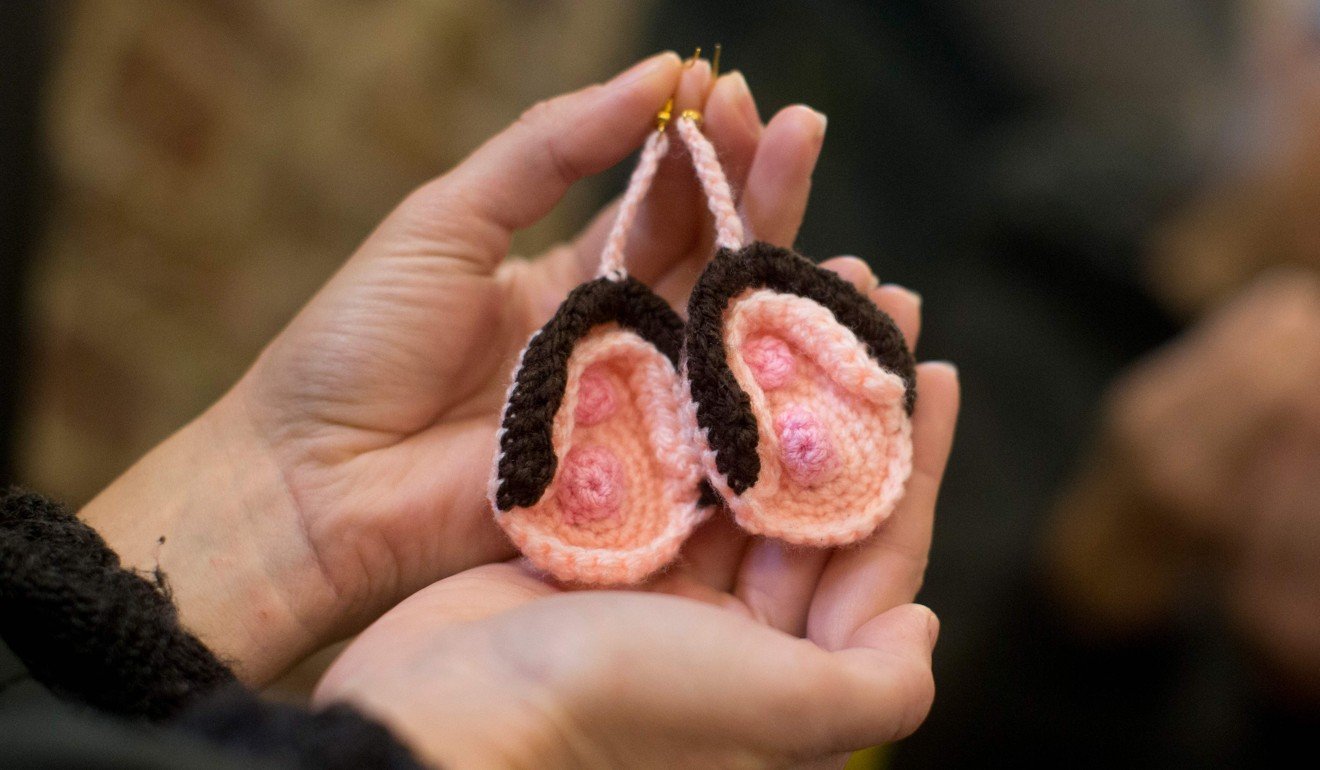 A visitor looks at a pair of crochet vulva earrings on sale during the press preview of the new Vagina Museum in London on Thursday. Photo: AFP